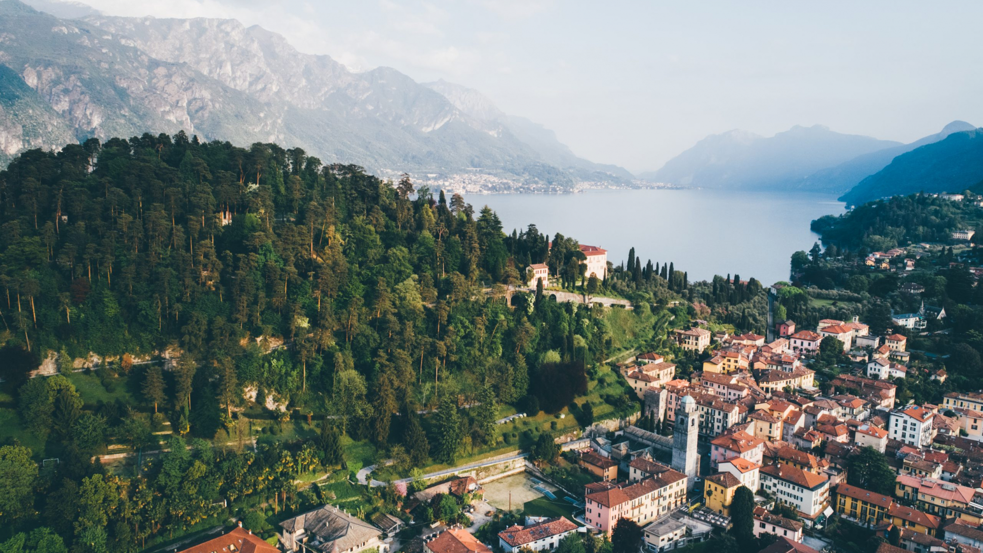 High top landscape of Bellagio city placed on cape with mountains and blue lake. Como, Italy.