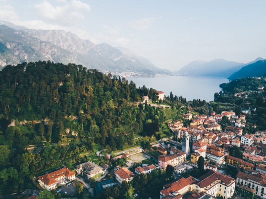 High top landscape of Bellagio city placed on cape with mountains and blue lake. Como, Italy.